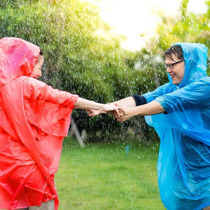  Person wearing the poncho while camping and hiking, emphasizing its practicality